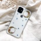 moon case with blue dried flower